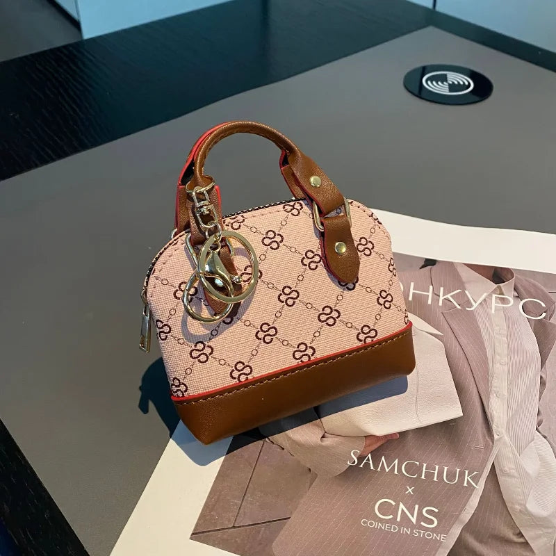 Chic Monogram Pattern Mini Dome Handbag with Top Handle and Keychain Accent