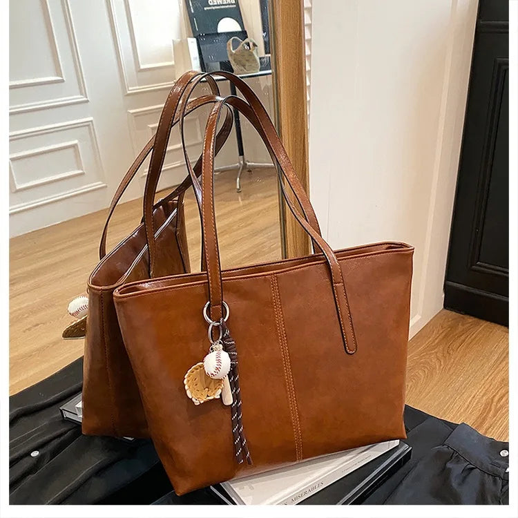 Classic Black Leather Tote Bag with Sports Charm – Spacious Work & Casual Shoulder Bag for Women