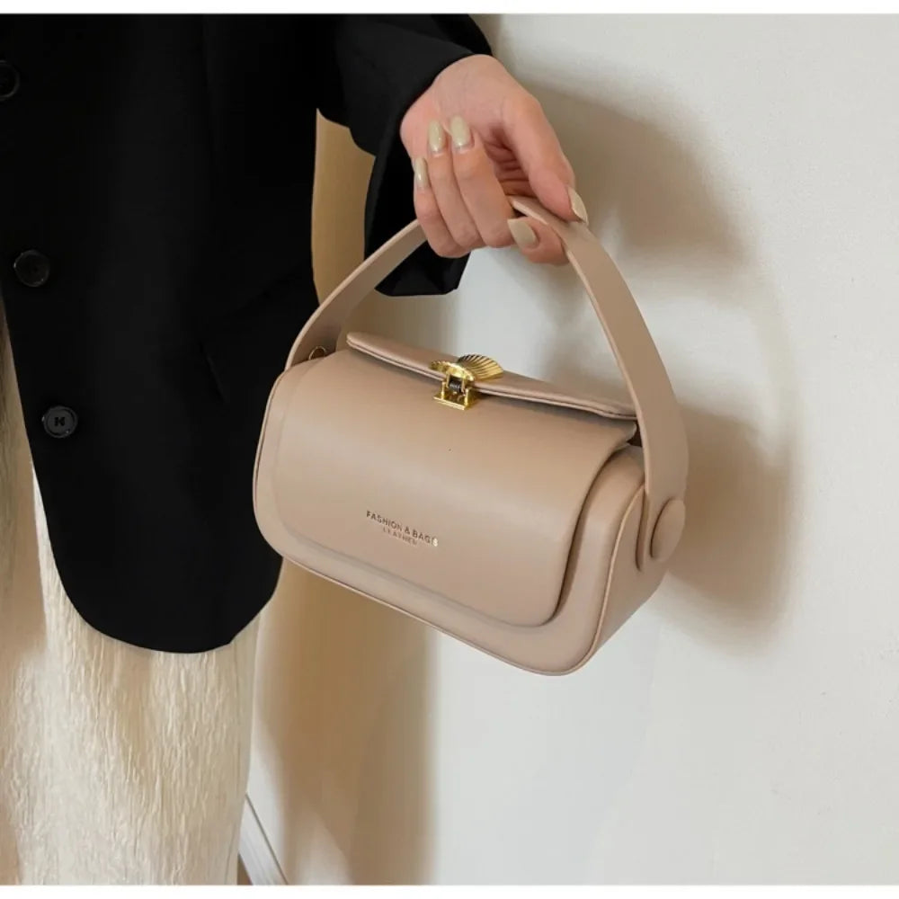 Elegant Black Box Handbag with Gold Clasp and Adjustable Strap