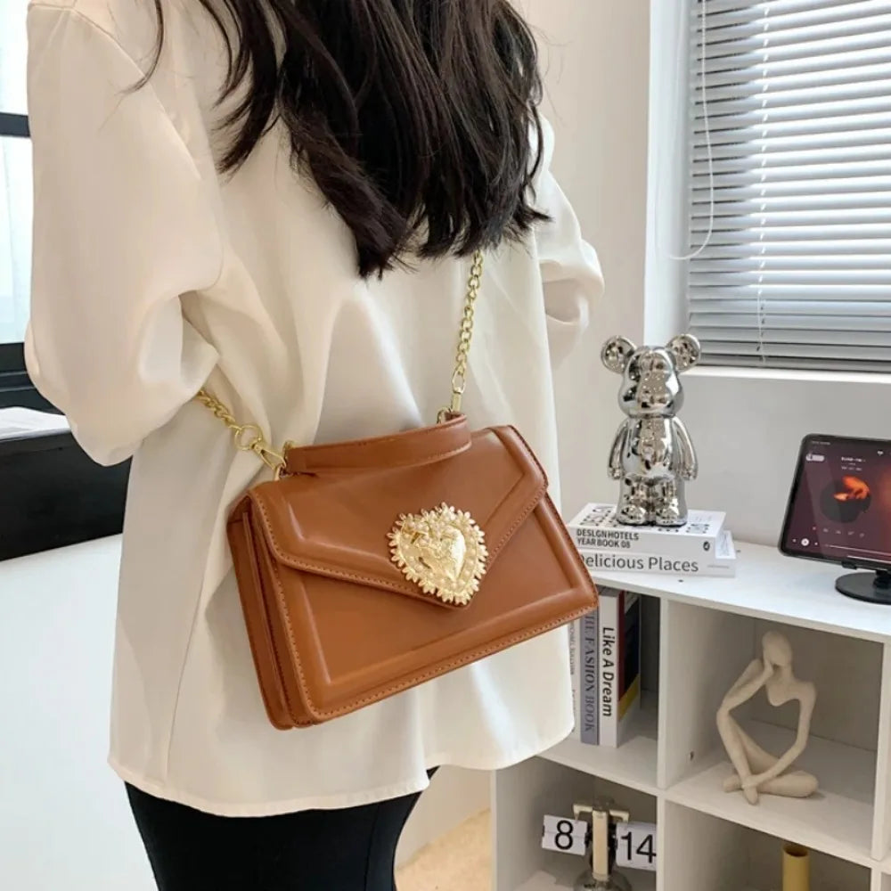 Aura Bags Elegant Brown Flap Handbag with Pearl-Accented Heart Clasp and Chain Strap