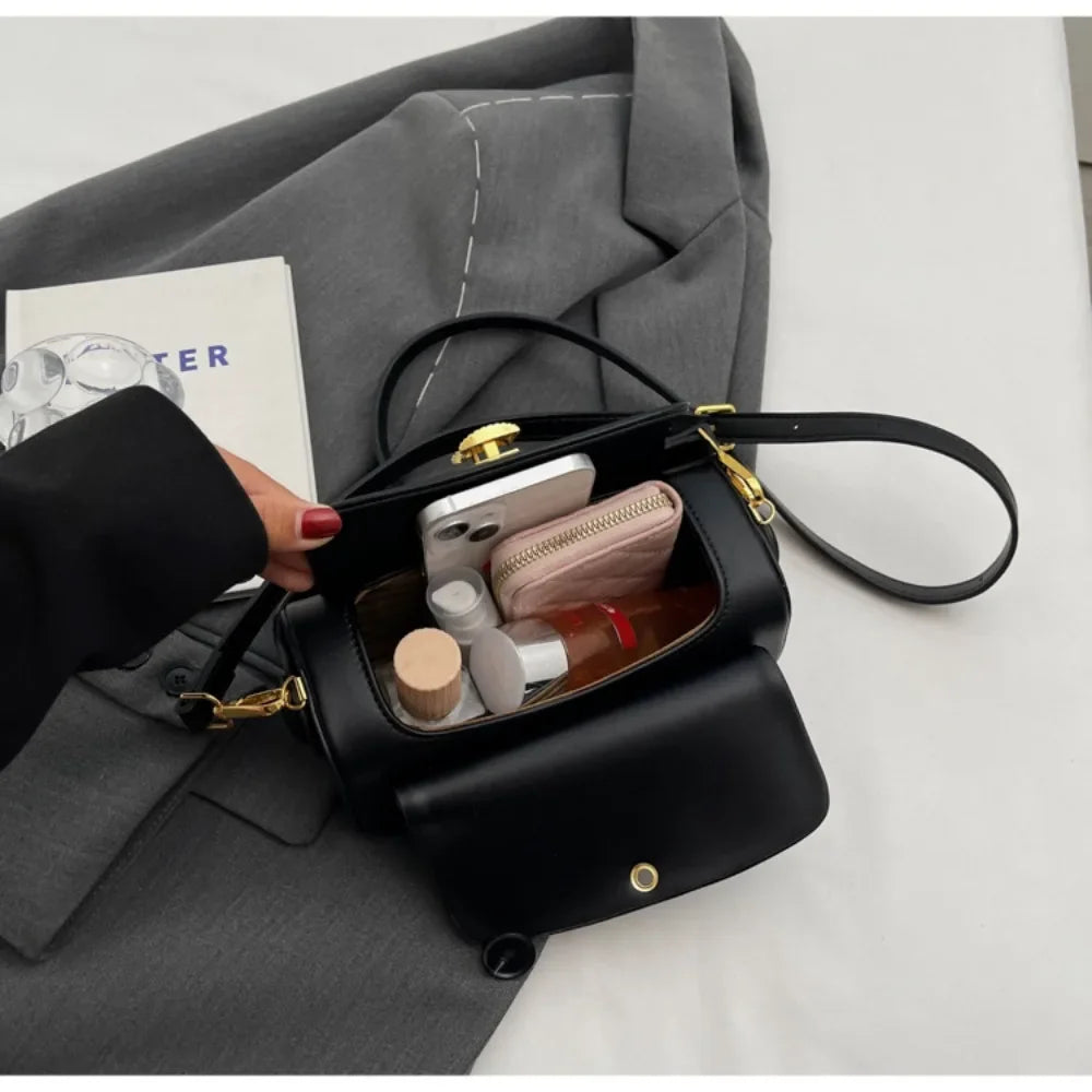 Elegant Black Box Handbag with Gold Clasp and Adjustable Strap