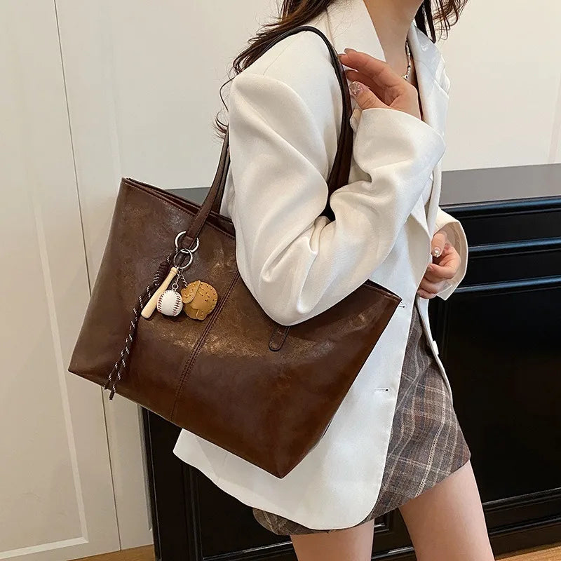 Classic Black Leather Tote Bag with Sports Charm – Spacious Work & Casual Shoulder Bag for Women