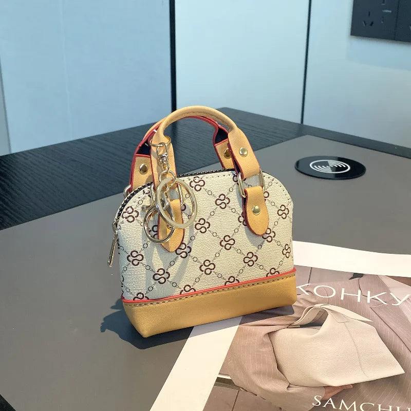Chic Monogram Pattern Mini Dome Handbag with Top Handle and Keychain Accent
