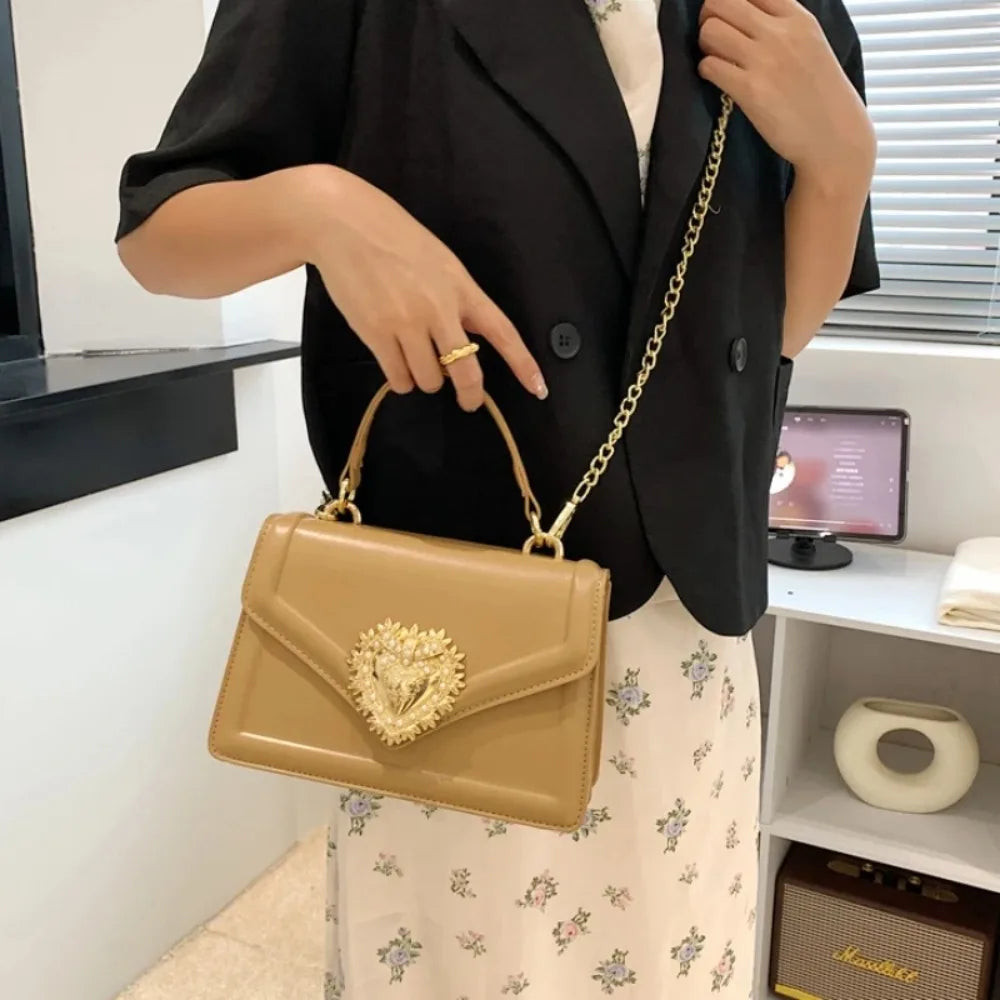 Aura Bags Elegant Brown Flap Handbag with Pearl-Accented Heart Clasp and Chain Strap