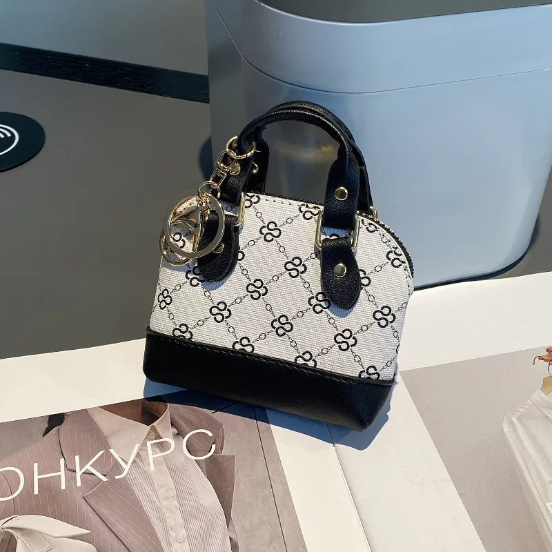 Chic Monogram Pattern Mini Dome Handbag with Top Handle and Keychain Accent